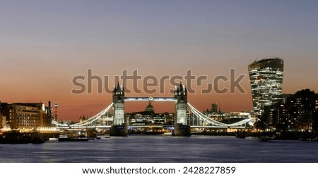 Panoramic view of tower bridge framing st. paul's cathedral with the city tower blocks at dusk, london, england, united kingdom, europe