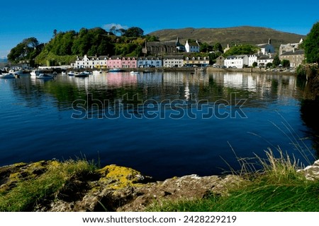A line of port houses forms the backdrop to the waterfront of portree harbour on the isle of skye, inner hebrides, scotland, united kingdom, europe