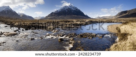 Panoramic view across river etive towards snow-covered mountains including buachaille etive mor, rannoch moor, near fort william, highland, scotland, united kingdom, europe