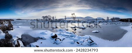 Panoramic winter view over frozen loch ba at dawn, rannoch moor, highland, scotland, united kingdom, europe