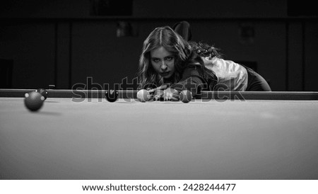 Focused young woman playing snooker game, aiming cue on balls. Online course banner for mastering billiards skills. Black and white. Concept of billiards sport, gambling, hobby, leisure, game