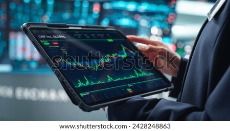 Close Up on a Tablet Computer Screen with Real-Time Stock Market Analytics, Graphs and Reports. Stock Exchange Software Template. Broker Monitoring Financial and Business Opportunities at Work