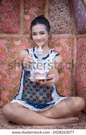 Beautiful girls wearing shirts that are hand-embroidered by hill tribe people but have a modern design in white skirts. Pretty fashionable young girl. Portrait of contemporary fashion of female.