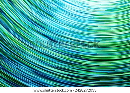 Neon circle lines with empty copy space inside isolated on black background. Colorful led lights long exposure rotation photo. Shiny light source. Cosmos space planet abstraction. Blue vortex spiral.	