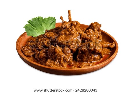 Mutton curry or Lamb curry with Lettuce Leaves, Letus pata on a wooden plate, is spicy Indian cuisine. Mutton gravy is a delicious Indian curry dish of soft. white background Isolated Royalty-Free Stock Photo #2428280043
