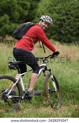 Portrait, bike and man cycling in countryside for adventure, discovery or off road sports hobby. Fitness, health and wellness with young cyclist on bicycle in nature for cardio training or exercise