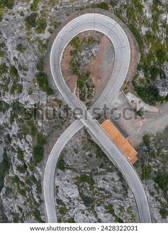 An aerial view of the Nus de Sa Corbata hairpin turn in the Serra Tramuntan of Mallorca near Coll de Reis mountain pass Royalty-Free Stock Photo #2428322031