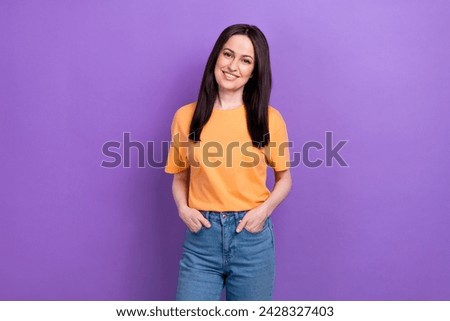 Portrait of adorable lovely girl with stylish hairdo wear oversize t-shirt holding arms in pockets isolated on violet color background