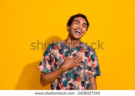 Photo of young funny cheerful guy touch chest and laughing in good mood humorous joke happy emotions isolated on yellow color background Royalty-Free Stock Photo #2428327545