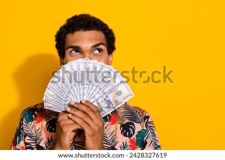Photo of young dreaming businessman looking empty space idea spend profit money he got from casino isolated on yellow color background