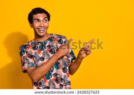 Photo of smiling guy t shirt pointing fingers empty space discount in supermarket for alcohol drinks isolated on yellow color background