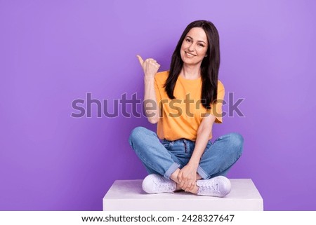 Full length photo of woman in casual outfit sit platform direct finger billboard open jobs vacancy isolated on purple color background