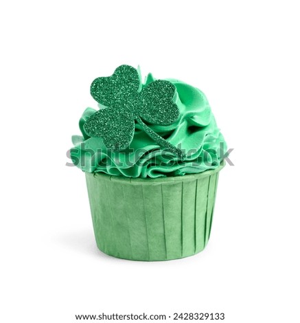 St. Patrick's day party. Tasty cupcake with green clover leaf topper and cream isolated on white