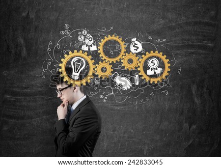 businessman thinking with gold gears on head Royalty-Free Stock Photo #242833045
