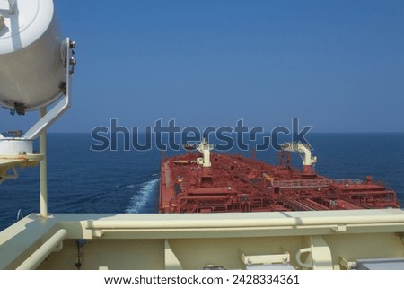 Merchant ship carrying chemical cargo is underway at sea on a sunny day under blue sky