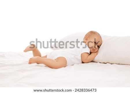 Sleepy baby. Cute, adorable little girl, toddler lying on bed on comfortable pillow against white background. Concept of childhood, family, care, motherhood, infancy, heath Royalty-Free Stock Photo #2428336473