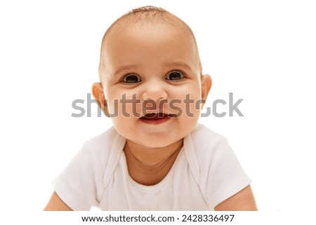 Portrait of beautiful, calm, adorable baby girl, child posing on bed in white clothes against white background. Concept of childhood, family, care, motherhood, infancy, heath Royalty-Free Stock Photo #2428336497