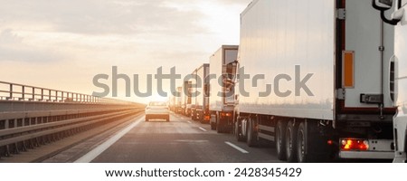 Queue of Trucks on Ukraine-Poland Border traffic jam at Sunset During Protest Roadblock. Business agricultural Logistics blockade action. Cargo lorry semi-trailers stuck