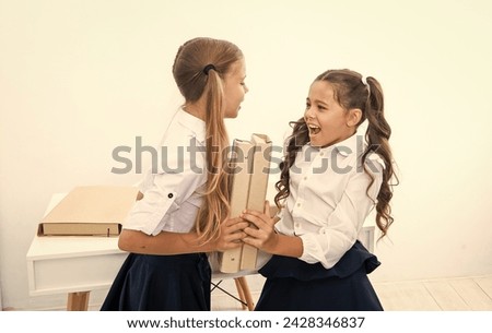 children girls on desk. ready for school lesson. two girls in school class. education and knowledge. children girls holding folder. high school education. school education for girls. solving problem Royalty-Free Stock Photo #2428346837