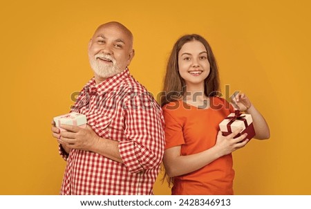 glad girl and granddad with present box for anniversary