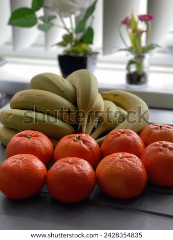 Bananas and oranges are two widely consumed and nutritionally rich fruits, each offering a unique set of benefits. Bananas, with their distinct curved shape and vibrant yellow peel, are a powerhouse o Royalty-Free Stock Photo #2428354835
