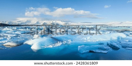 Panorama of mountains and icebergs locked in the frozen water, jokulsarlon iceberg lagoon, jokulsarlon, south east iceland, iceland, polar regions