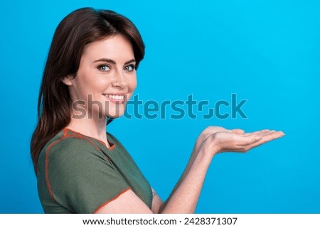 Profile photo of nice positive lady beaming smile hands palms hold demonstrate empty space ad isolated on blue color background