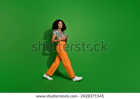 Full body length photo of ads manager specialist young girl steps make money from content in tiktok app isolated on green color background