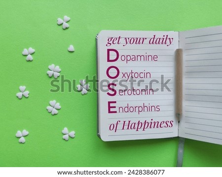 Happy brain chemicals written on a sheet of paper with decorations in the shape of heart and clover. DOSE of hormones for mental health. Dopamine, Oxytocin, Serotonin, Endorphin. Hormones of happiness Royalty-Free Stock Photo #2428386077