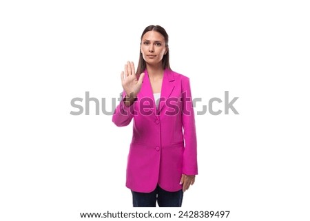 a young caucasian brunette business lady dressed in a bright raspberry jacket uses gestures in a conversation