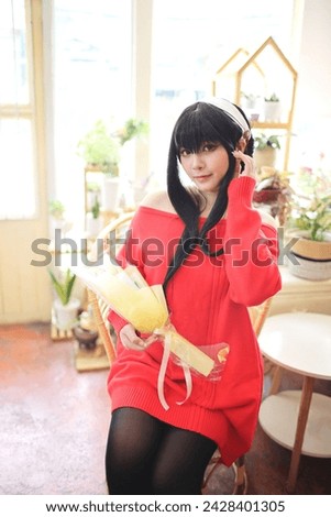 Portrait of a beautiful young woman Cosplay with red sweater at flower shop