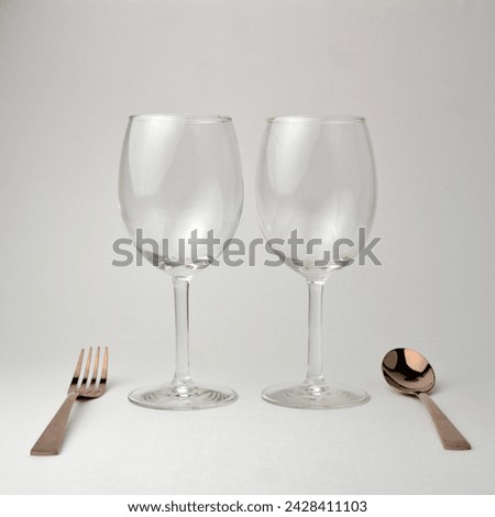 Glassware jars spoons forks on white background