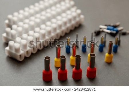 Close up several Wire Ferrule and terminal block w wire on top of a black table Royalty-Free Stock Photo #2428412891