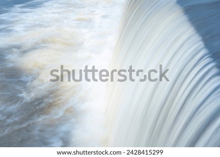 A pure white waterfall background formed in the river througha check dam