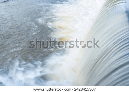 A pure white waterfall background formed in the river througha check dam