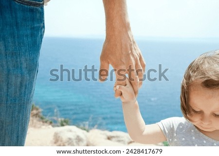 hands of happy parents and children at sea in travel background in greece