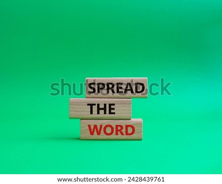 Spread the Word symbol. Concept words Spread the Word on wooden blocks. Beautiful green background. Business and Spread the Word concept. Copy space.
