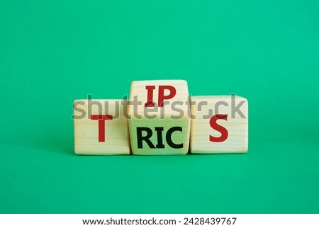 Tips and Tricks symbol. Wooden cubes with words Tricks and Tips. Beautiful green background. Business and Tips and Tricks concept. Copy space