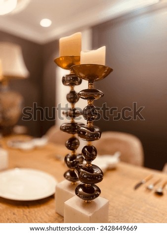 A candle stand is a decorative holder designed to support candles. It comes in various shapes, sizes, and materials, such as metal, wood, or glass.
