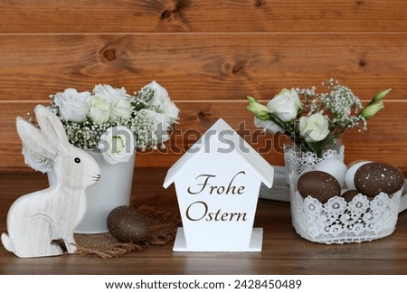 Happy Easter: Bouquet of flowers with Easter eggs and the inscription Happy Easter. German inscription translates as Happy Easter.
