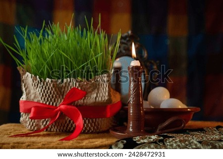 Burning candle on the festive table Nevruz