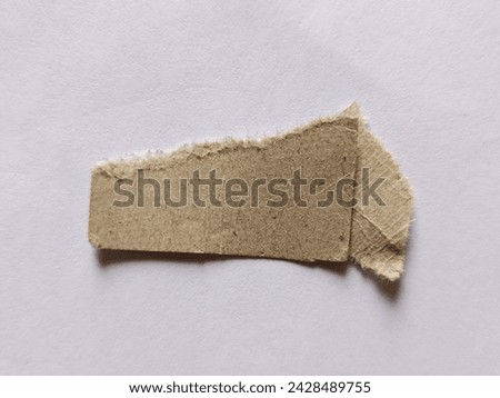 a piece of brown paper on white paper