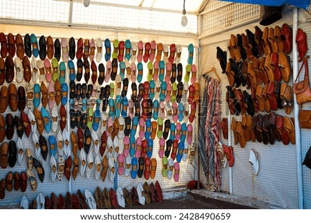 Handcrafted traditional shoes sold in a souvenir shop in the village of Sidi Bou Said, Tunisia near the capital of Tunis (a UNESCO world heritage site) Royalty-Free Stock Photo #2428490659