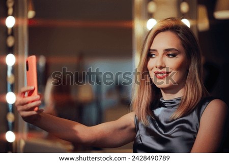 
Woman Wearing Professional Makeup in a Salon Taking Selfies
Stunning confident lady wearing red lips checking herself in the phone camera
