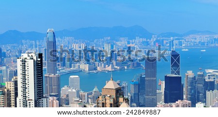 Victoria Harbor aerial view with Hong Kong skyline and urban skyscrapers in the day.