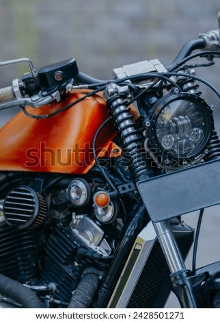 Close-up of  motorbike with  orange tank. Vintage motorbike detail.