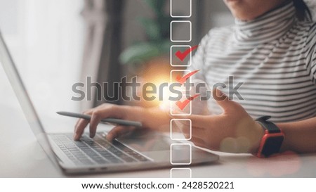 Checklist concept. Businesswoman using a laptop. Checking marks on checkboxes on the futuristic virtual interface screen	