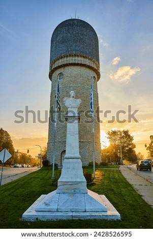 Golden Hour at Ypsilanti Water Tower with Marble Bust and Flags Royalty-Free Stock Photo #2428526595