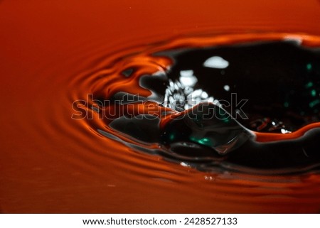 Vibrant Orange and Dark Green Water Splash Art, High-Speed Capture