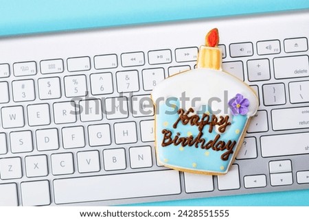 Birthday cake shaped cookies with keyboard.